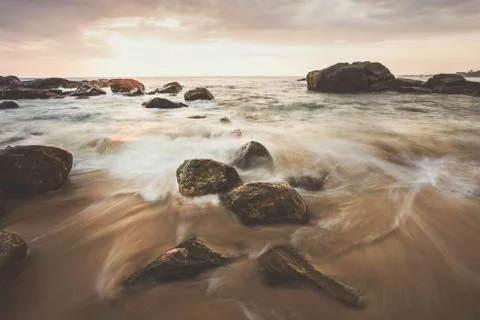 Long exposure capture with beach, reef and rocks.. Stock Photos