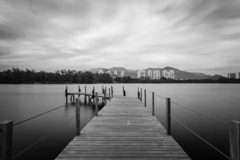 Long exposure of deck in lake, cloudy skies Foto stock
