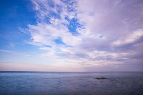 Long exposure image of Dramatic sky seascape with rock in sunset scenery ba.. Stock Photos