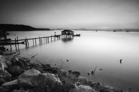 Long exposure image of old abandoned fisherman jetty in black and white. Stock Photos