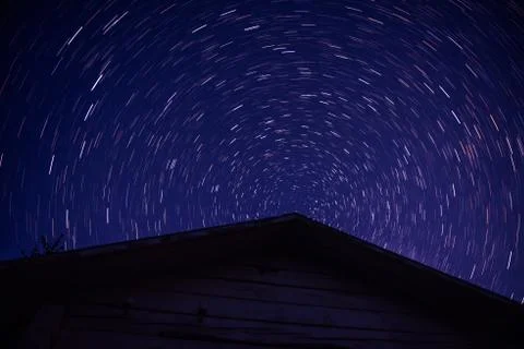 Long exposure image showing star trails over abandoned house, Stock Photos