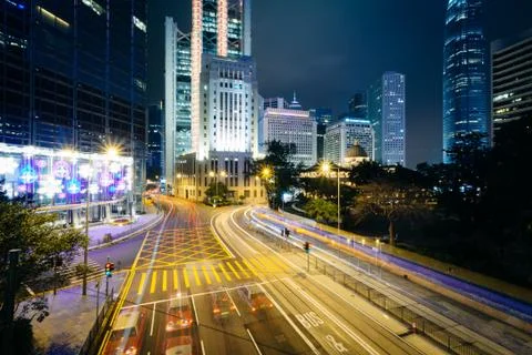 Long exposure of an intersection and modern skyscrapers at night, at Central, Stock Photos