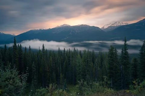 Long exposure of mist rolling through the valley in Banff National Park in the Stock Photos