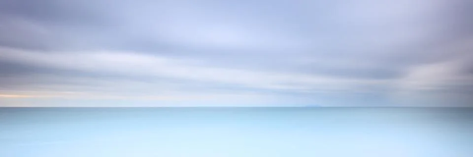 Long exposure photography panorama 3:1 with soft sea and cloudy sky Stock Photos