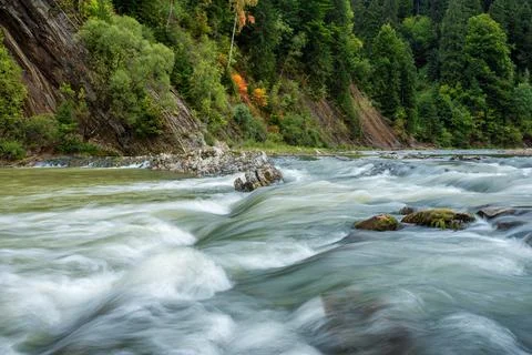 Long exposure rapids of a mountain river with shallow depth of field Stock Photos