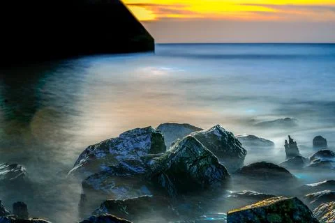 Long exposure of a romantic seascape with rocks Stock Photos