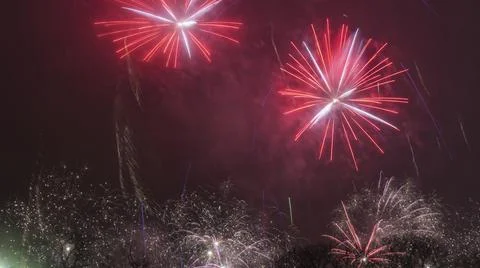 A long exposure showing multiple firework explosions. Fireworks celebration.  Stock Photos