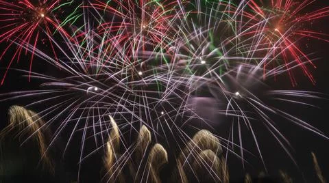 A long exposure showing multiple firework explosions. Fireworks celebration.  Stock Photos