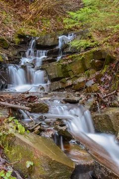 Long exposure of a small water course in Transylvania forests, Romania Stock Photos