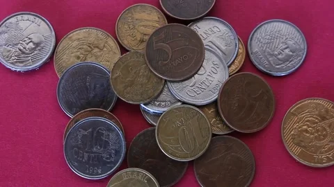 Long exposure time lapse from a man tossing coins of brazilian real over a color Stock Footage 233034743