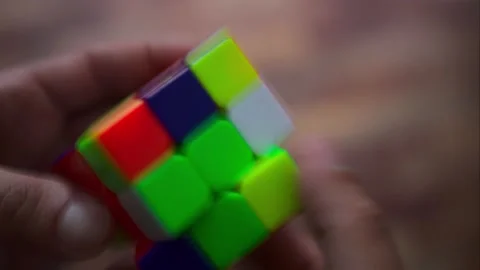 A long exposure time lapse shot of a man solving a rubiks cube  Stock-Footage 152048983