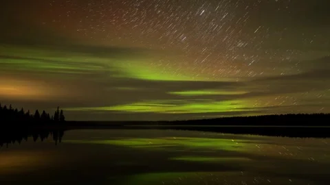 Long exposure timelapse of multicolored aurora above a calm northern lake  Stock Footage 278682703