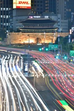 Long exposure of traffic lights in front of illuminated Sungnyemun gate at .. Stock Photos