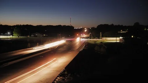 Long Exposure Traffic Time Lapse of a Rural Busy Intersection at Sunset Stock Footage 106753928