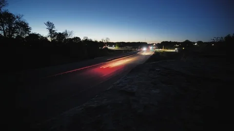 Long Exposure Traffic Time Lapse Tracking Shot of a Busy Intersection at Sunset Stock Footage 106765902