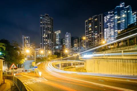 Long exposure of traffic on Upper Albert Road, and modern skyscrapers at nigh Stock Photos