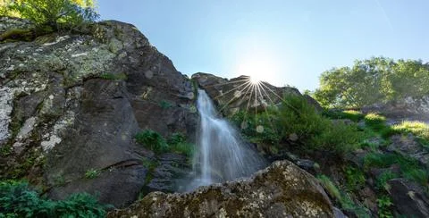 Long exposure under the waterfall with starry sun Stock Photos