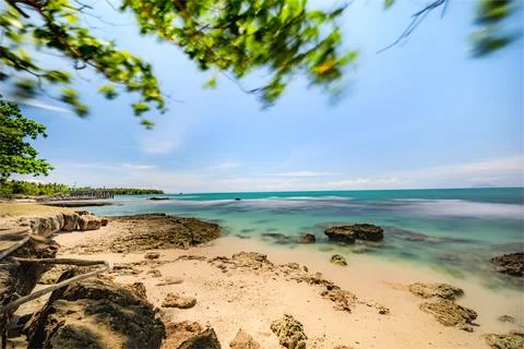 Long Exposure of Waves on a Sandy Beach. Crystal Clear Waters on a Bright S.. Stock Photos