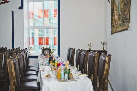 Long festive table with several chairs for guests  Stock Photos
