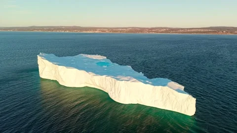 Long Flat Iceberg Meltwater Pool Golden Light Dusk Newfoundland Video stock 334648922
