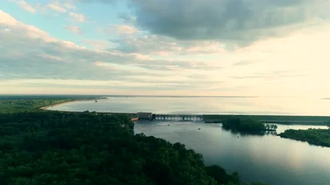 Long flight over forest and river approaching a dam at full release at dawn.. Stock Footage 138049244