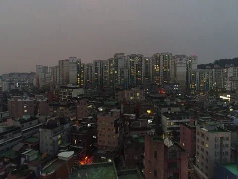 Long flyover toward and over tall apartment buildings Stock Footage 77981618