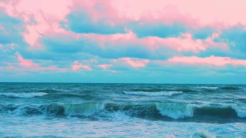 Long Foaming Waves in the Ocean Rolling on the Shore and Beautiful Light Pink Co Video stock 281559055