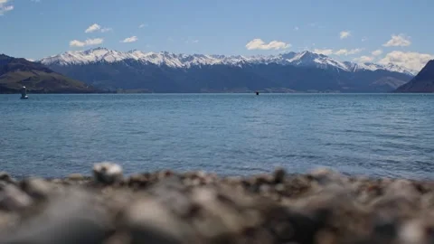 Long focus of scenic mountain range over Lake Hawea Stock-Footage 328134607