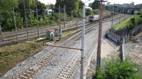 Long freight train and passenger train cross each other Stock Footage 290036165