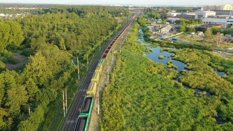 A long freight train with building materials is moving by railway on the 스톡 동영상 113113673