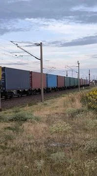 Long freight train with containers at sunset Stock Photos