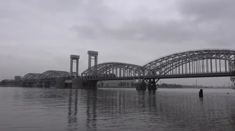 Long freight train crosses the Neva River along metallic bridge Stock Footage 67468128