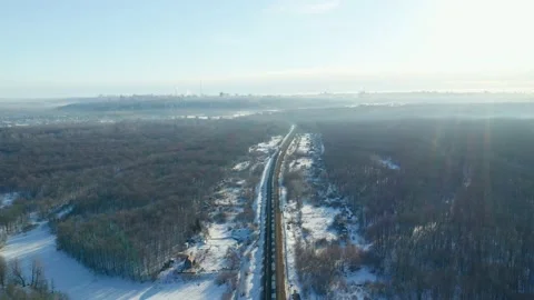 A long freight train on a lonely railroad in the middle of the forest in winter Stock Footage 152980122