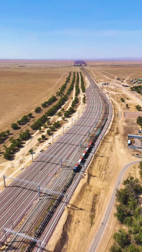 Long Freight Train Moving Along Multiple Railway Tracks in Steppe Stock Footage 346320706