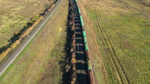 Long freight train is moving through the autumn countryside in sunny day Stock Footage 287093284