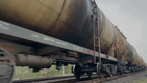 Long freight train rolling by a rural area on its way Stock Footage 152994986