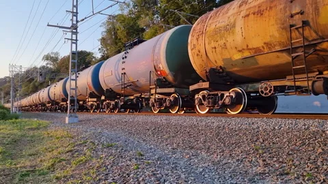 Long freight train transporting oil tankers is traveling on a railway track Stock Footage 287837473