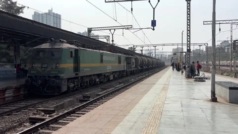Long Fuel Tanker Freight Train Crossing Station in Heavy Urban Smog and Haze Stock Footage 329346691