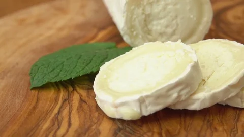 Long goat cheese with bread on the background Stock Footage 71277934