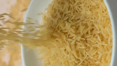 Long grain parboiled basmati rice pouring macro vertical slow motion 스톡 동영상 268441587