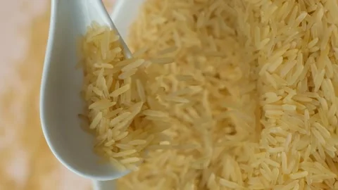 Long grain parboiled basmati rice pouring with spoon macro vertical slow motion 스톡 동영상 269680191