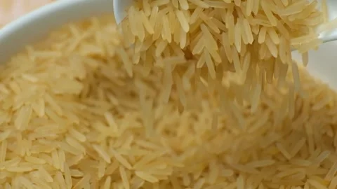 Long grain parboiled basmati rice pouring with spoon macro slow motion Stock Footage 270738646