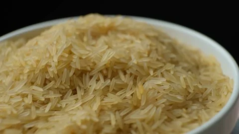 Long grain parboiled basmati rice rotating on black background Stock Footage 272426348