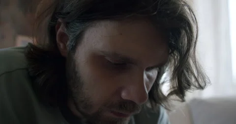 Long-haired, bearded man: sad, divorced, unemployed. Bachelor, depression Stock Footage 245769116