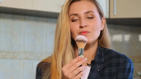 Long haired blogger blows on brush with powder Video stock 131073117