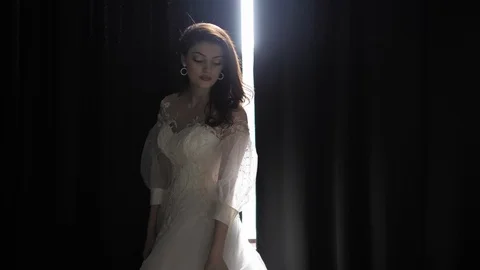 Long haired bride poses against curtains clearance in studio Stock Footage 126604820