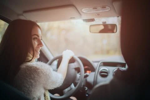 Long-haired brunette on the auto background. A female model is wearing a sweater Foto stock