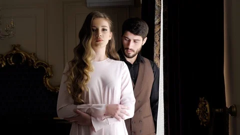 Long haired brunette stands in front of man slow motion Stock Footage 105934871