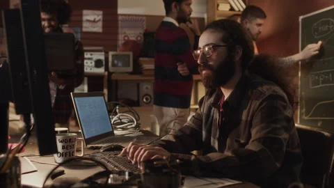 Long Haired Geek Working on Computer in Handmade Office Stock Footage 263297564
