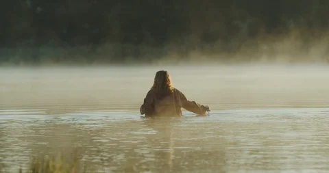 Long haired girl strolling down a swamp with a treasure chest and knife in her Stock Footage 96490033